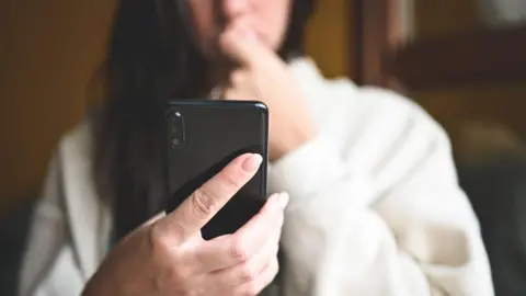 A woman looking at her phone 