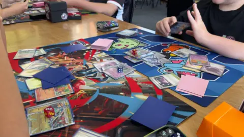A Pokémon trading card game on a table at a gaming café in Nottingham.