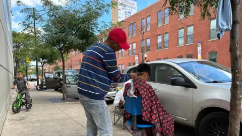 Brandon Drenon/BBC News  Migrants at a shelter in Chicago. 