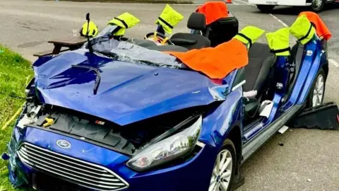 A car that has had its roof taken off by firefighters in Stanford, Bedfordshire