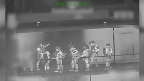 Multiple soldiers are seen holding guns.