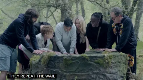 BBC A scene from Celebrity Traitors around a well