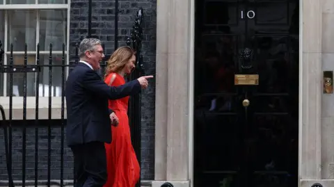 Getty Images Britain's incoming Prime Minister Keir Starmer and leader of the Labour Party, and his wife Victoria enter 10 Downing Street in London