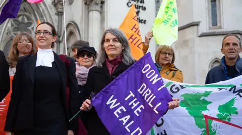 Getty Images Sarah Finch stands with a lawyer outside the Court of Appeal in 2021.
