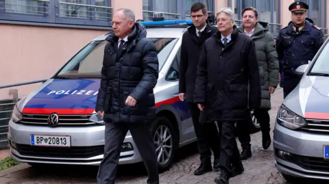 Austria's interior minister and other officials prepare to give a news conference on the attack