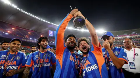 ICC via Getty Images Kuldeep Yadav and Sanju Samson of India celebrate after victory in the ICC Men's T20 World Cup India & Sri Lanka 2026 Final between India and New Zealand at Narendra Modi Stadium on March 08, 2026 in Ahmedabad, India. 