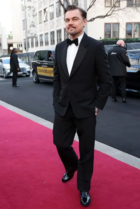 Getty Images Leonardo DiCaprio in evening dress and a bow tie, on the red carpet