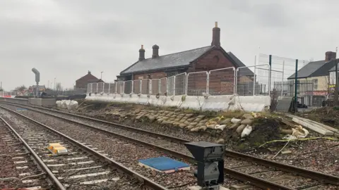 Bedlington station is a derelict brick building surrounded by fencing 