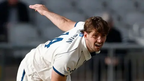 Derbyshire's Ben Aitchison bowls during the County Championship Division Two match against Lancashire at the Emirates, Old Trafford, Manchester in April 2026