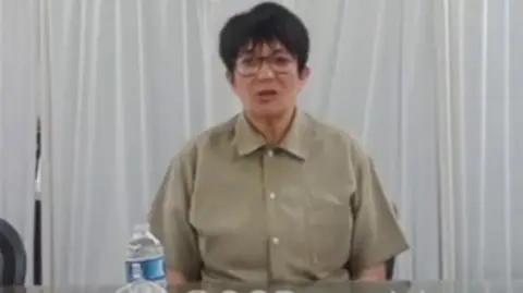 Ghislaine Maxwell sits during her deposition