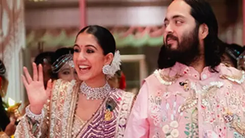 Reuters Anant Ambani and Radhika Merchant wave at guests during their wedding