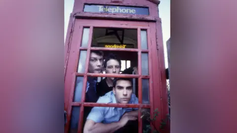 Getty Images Photograph of the original Stereophonics line-up in a red phone box -  Richard Jones, Stuart Cable and Kelly Jones pictured. 