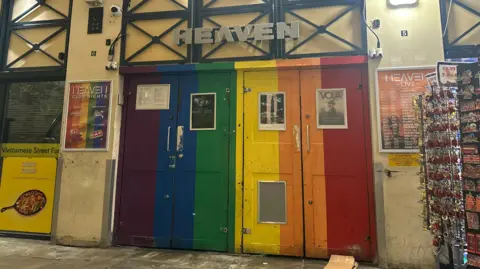 The Pride-themed doors of Heaven - the two doors are coloured purple, blue, green, yellow, orange and red
