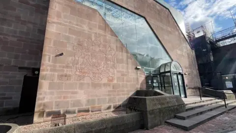 The entrance of Nottingham Crown Court with scaffolding around the right side of the building. 