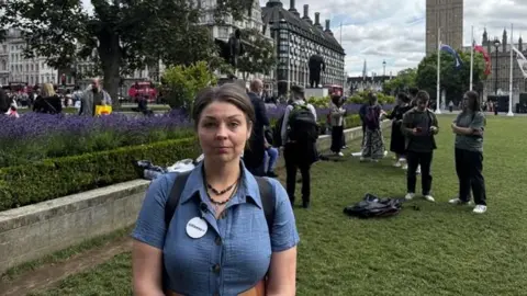 BBC Former carer Suzie Lyle rallying in Parliament Square with Citizens UK
