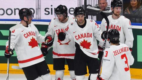 Canada players celebrate scoring against Great Britain at the Ice Hockey World Championship in Prague
