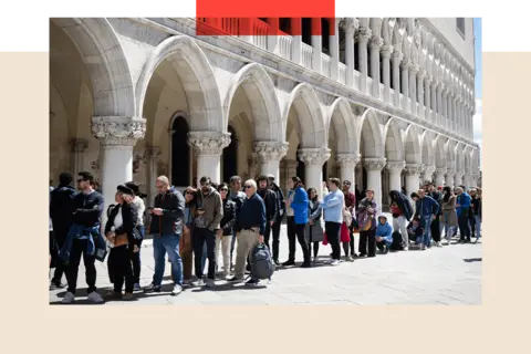 Getty Images A queue of tourists in Venice