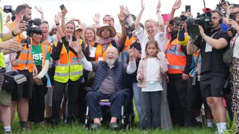 Organiser Emily Eavis and her father, co-founder Sir Michael Eavis, open the gates on the first day of the Glastonbury Festival.