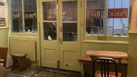 The Boot Inn Interior shot of the damaged door and surrounding windows