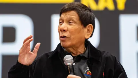 Getty Images Former Philippine President Rodrigo Duterte speaks at a campaign rally held at Southorn Stadium in Hong Kong, China on March 9, 2025. 