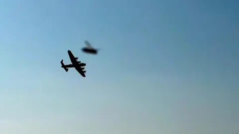 Kay Stevenson A World War Two Lancaster aircraft in flight with a bee 