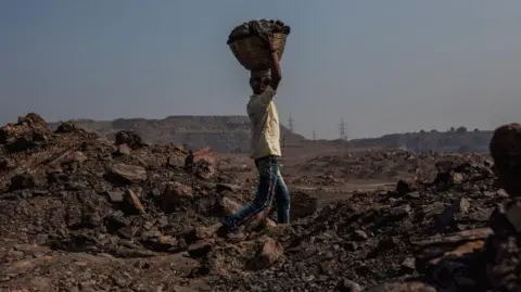 Getty Images A worker in the Jharia coal mine are carrying blocks of coal in basket on top of his head. According to the World Economic Forum, in 2020, India was home to six out of 10 of the world's most polluted cities. 