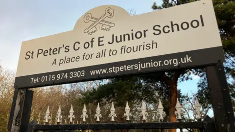 Large white sign with the school's name on it