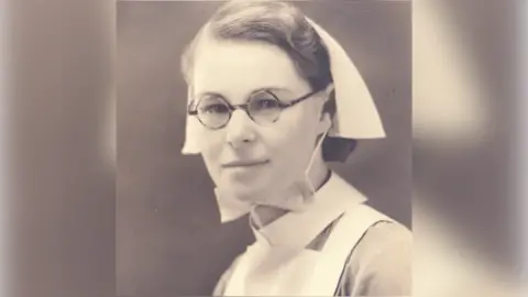 Black-and-white photo of Sister Mollie Evershed wearing nurse's cap and apron.