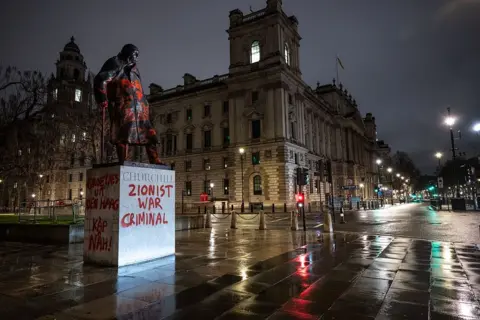 Getty Images The Churchill statue, in Parliament Square, seen vandalisedwith red paint and pro-Palestine slogans including "Zionist war criminal"