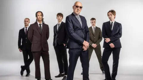 Pete Townshend (centre) posing in mod suits with the cast of Quodrophenia: A Mod Ballet.