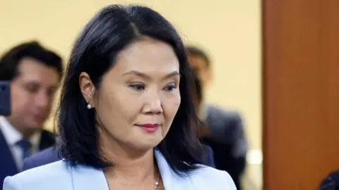 Getty Peruvian former presidential candidate and congresswoman Keiko Fujimori appears before a specialized corruption court at the opening of her trial for money laundering in the Odebrecht case in Lima on July 1, 2024. She could face up to 30 years in prison for the charges. 