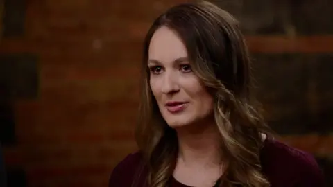 Annika Albrecht speaks in a brown shirt