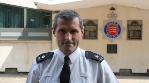 John Fairhall/BBC Supt Leigh Norris looks directly at the camera, dressed in police uniform.