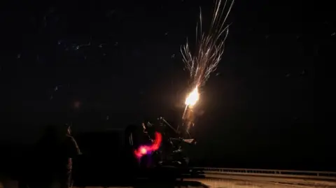 Ukrainian soldiers from an air defence unit fire at a Russian drone in the eastern Donetsk region. Photo: 15 April 2025