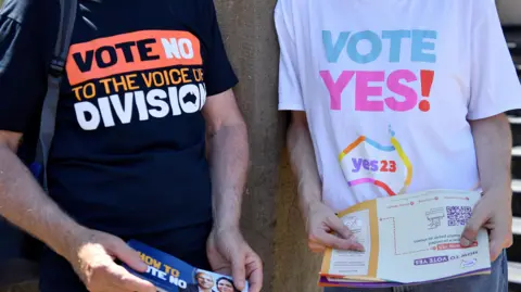 EPA Campaigners from both the 'No' and 'Yes' camps in Australia's Voice to Parliament referendum hand out fliers in front of polling stations 