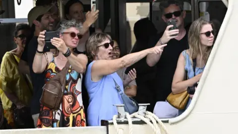 EPA Onlookers point their cameras toward Jeff Bezos (not pictured) and guests, spotting them from a boat in Venice.