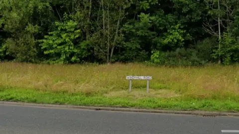 A sign showing the word Windyhill road 