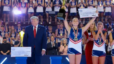 US President Donald Trump appears onstage with athletes during the 2026 Patriot Games final at SPIRE Academy in Geneva, Ohio