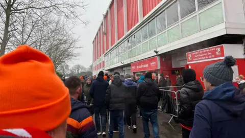 Protestors walking outside the Arkells Stand at County Ground