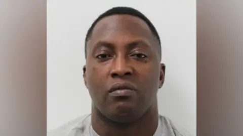 Met Police Police custody photograph showing a man facing the camera against a plain light-grey background.