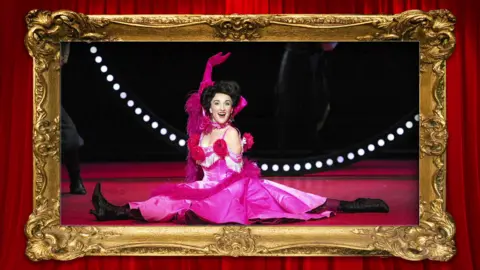 Opera North A woman in a pink dress pictured singing on stage as she performs in the Merry Widow