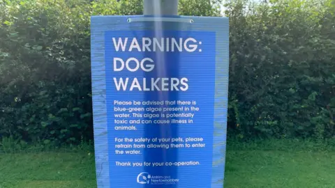 Warning sign for dog walkers