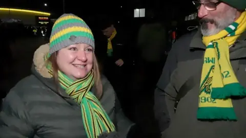 Norwich City fan smiling at Carrow Road after a win