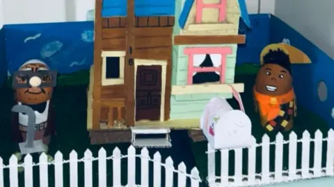 Janeane Kearney/PA Wire Eggs as Carl Fredricksen and Russell are shown in front of a depiction of Carl's house from Up