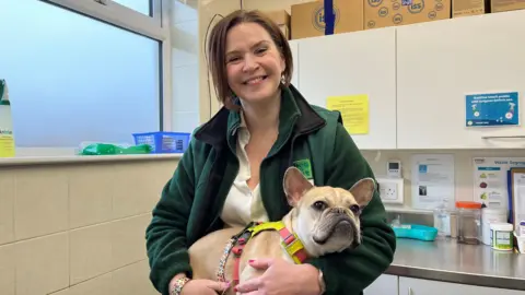 Lindsay Fyffe-Jardine, chief executive of the Edinburgh dog and cat home, standing with Lady Ruby, a french bulldog