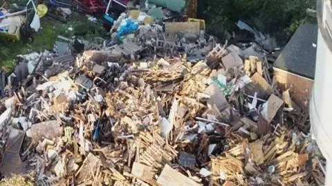 Environment Agency A huge pile of waste made up out of wood, metal, building waste and other mess.