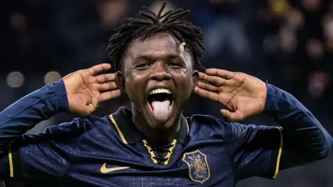 Zadok Yohanna cups both ears in celebration and sticks his tongue after scoring for AIK Stockholm