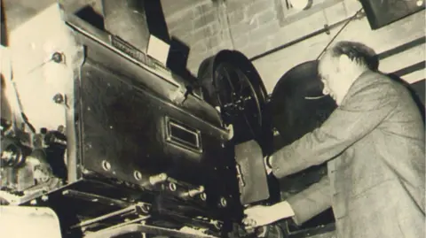 Leiston Film Theatre Peter Free operating the theatre equipment 