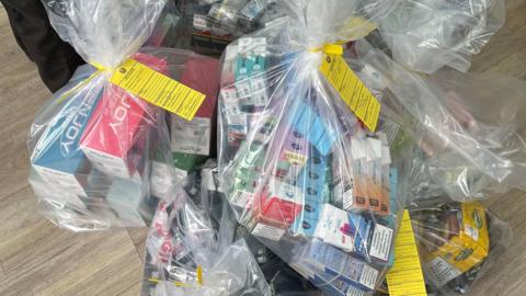 Suspected illicit vapes and tobacco products in plastic bags