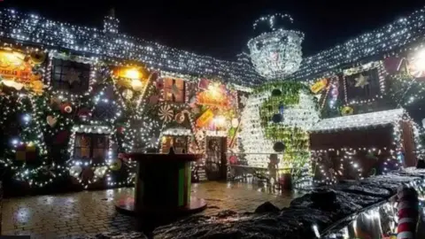 Somerset Live The pub covered in Christmas lights with the theme of the Gingerbread Man  and a giant snowman made of 2,500 wine bottles.